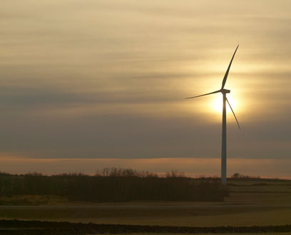 Sunsets behind wind turbines